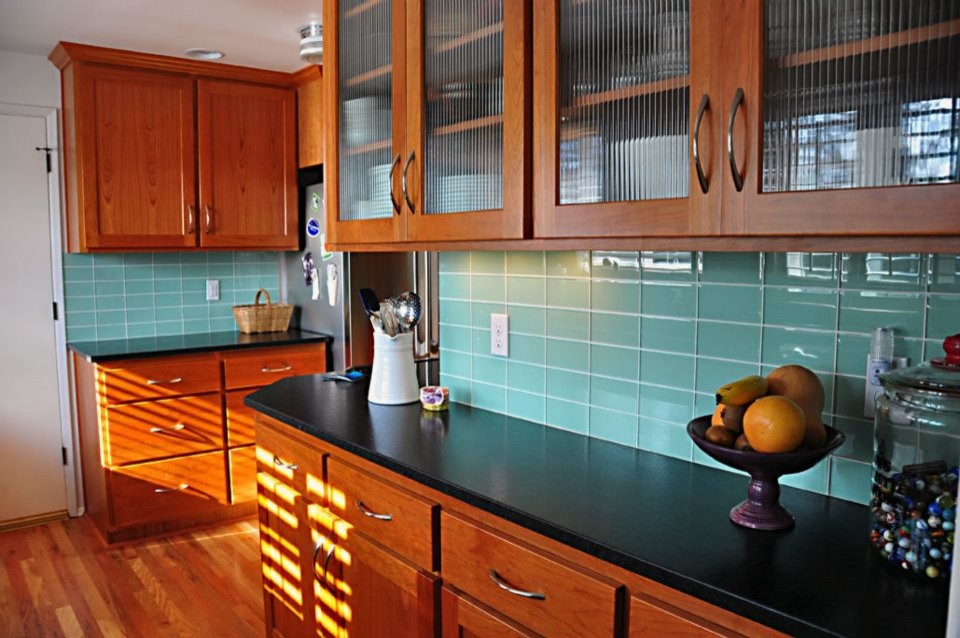 Photo of a modern kitchen in Other with blue splashback and glass tile splashback.