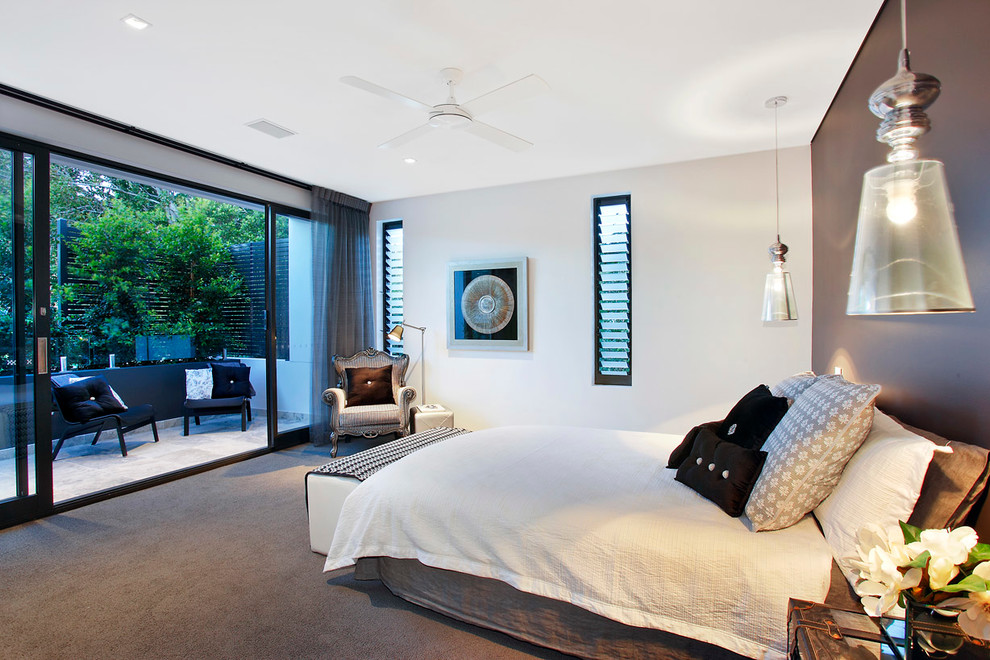Large contemporary master bedroom in Sydney with grey walls, carpet and no fireplace.