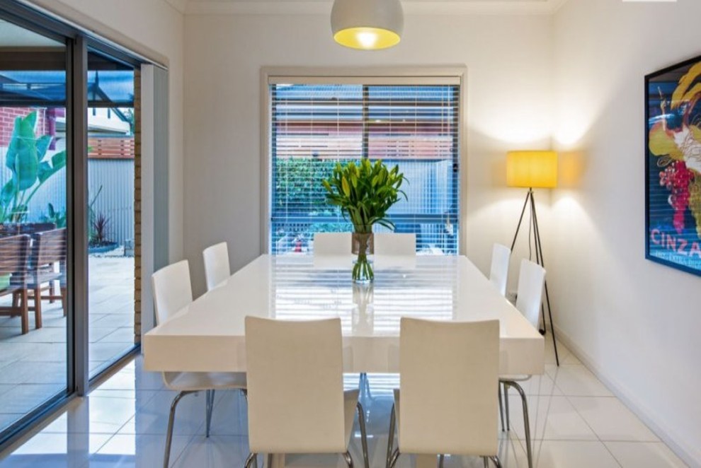 Design ideas for a modern dining room in Adelaide with white walls and ceramic floors.