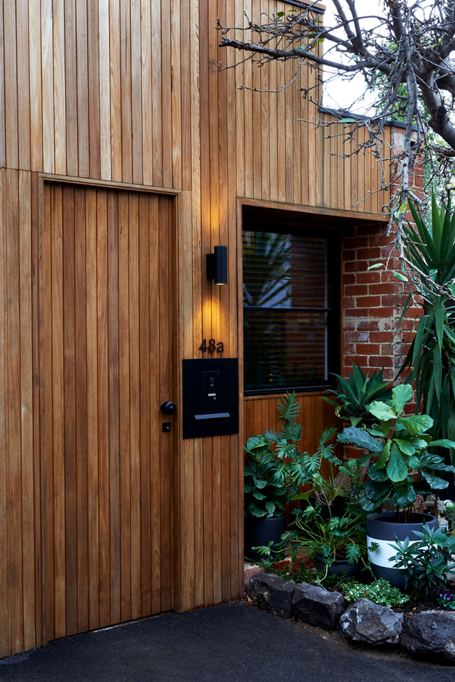 Design ideas for a large contemporary two-storey multi-coloured exterior in Melbourne with mixed siding and a flat roof.