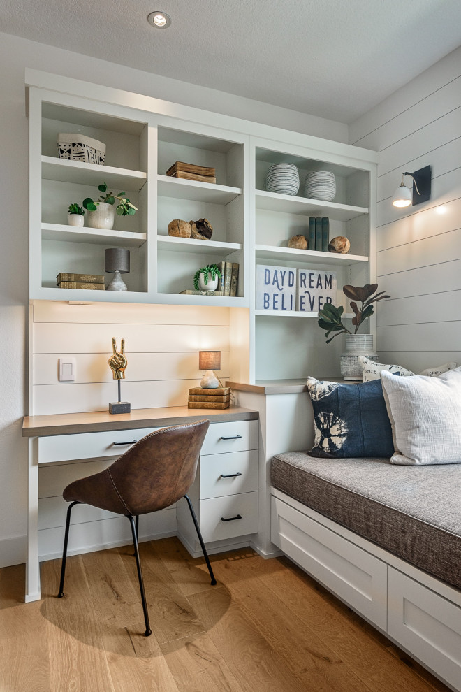 Photo of a country teen room in Portland with white walls and light hardwood floors.