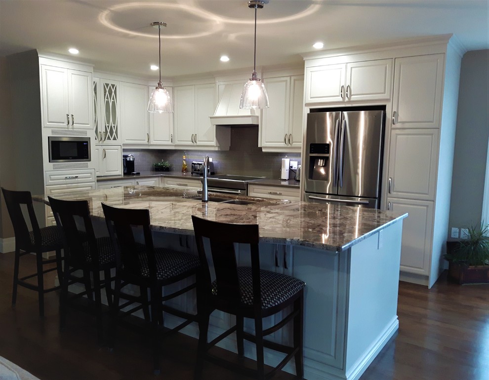 Large transitional medium tone wood floor and brown floor eat-in kitchen photo in Other with an undermount sink, raised-panel cabinets, granite countertops, stainless steel appliances, an island and beige countertops