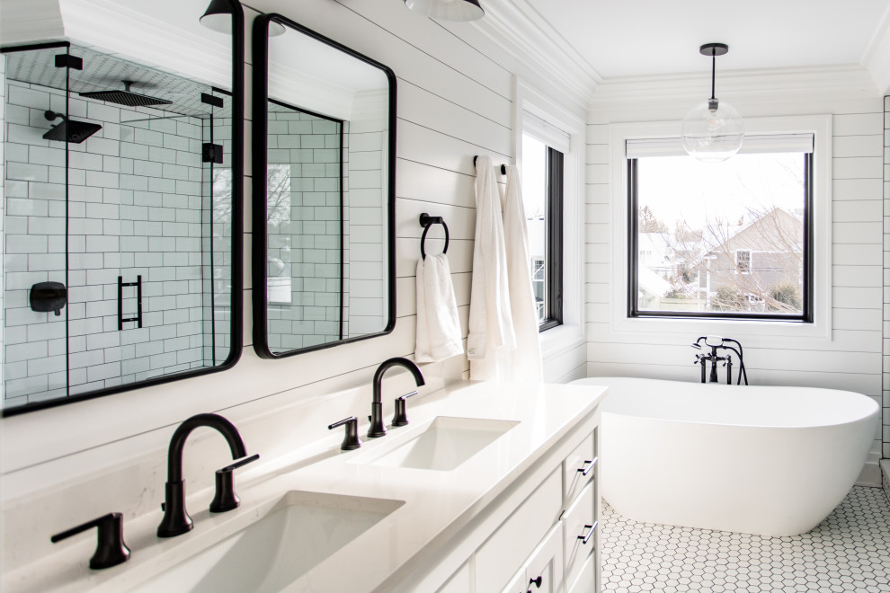 Photo of a large country master bathroom in Minneapolis with shaker cabinets, white cabinets, a freestanding tub, an open shower, a two-piece toilet, white tile, subway tile, white walls, ceramic floors, an undermount sink, engineered quartz benchtops, white floor, a hinged shower door, white benchtops, an enclosed toilet, a double vanity, a built-in vanity and planked wall panelling.