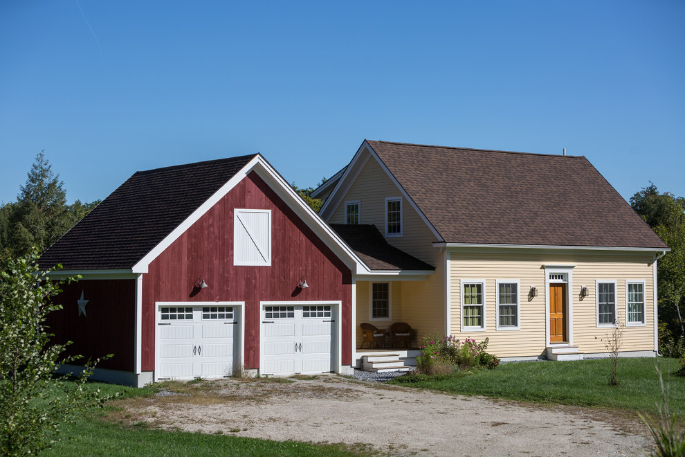 This is an example of a mid-sized country one-storey yellow house exterior in Boston with wood siding, a gable roof and a shingle roof.