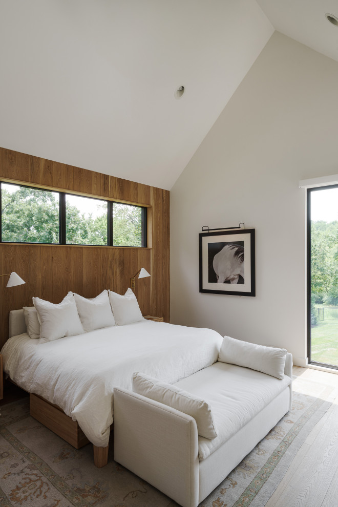 Inspiration for a large contemporary master light wood floor and vaulted ceiling bedroom remodel in Kansas City with white walls