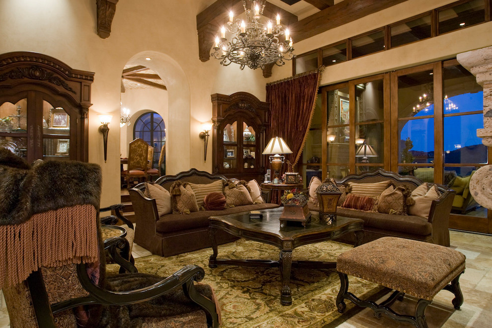 Inspiration for an expansive mediterranean enclosed family room in Phoenix with beige walls, medium hardwood floors, a standard fireplace, a stone fireplace surround, no tv and a library.