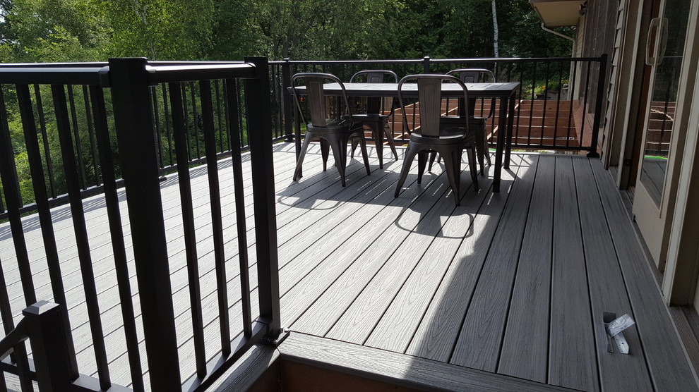 Large backyard deck photo with a roof extension