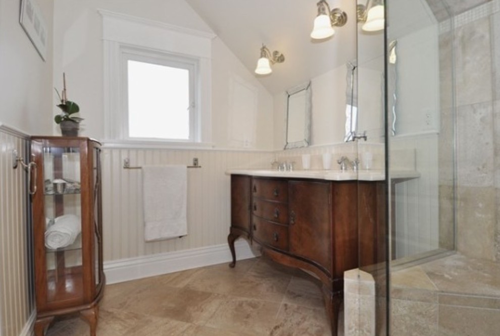 Mid-sized country master bathroom in Vancouver with furniture-like cabinets, dark wood cabinets, a corner shower, brown tile, ceramic tile, white walls, ceramic floors, an undermount sink, brown floor and a hinged shower door.