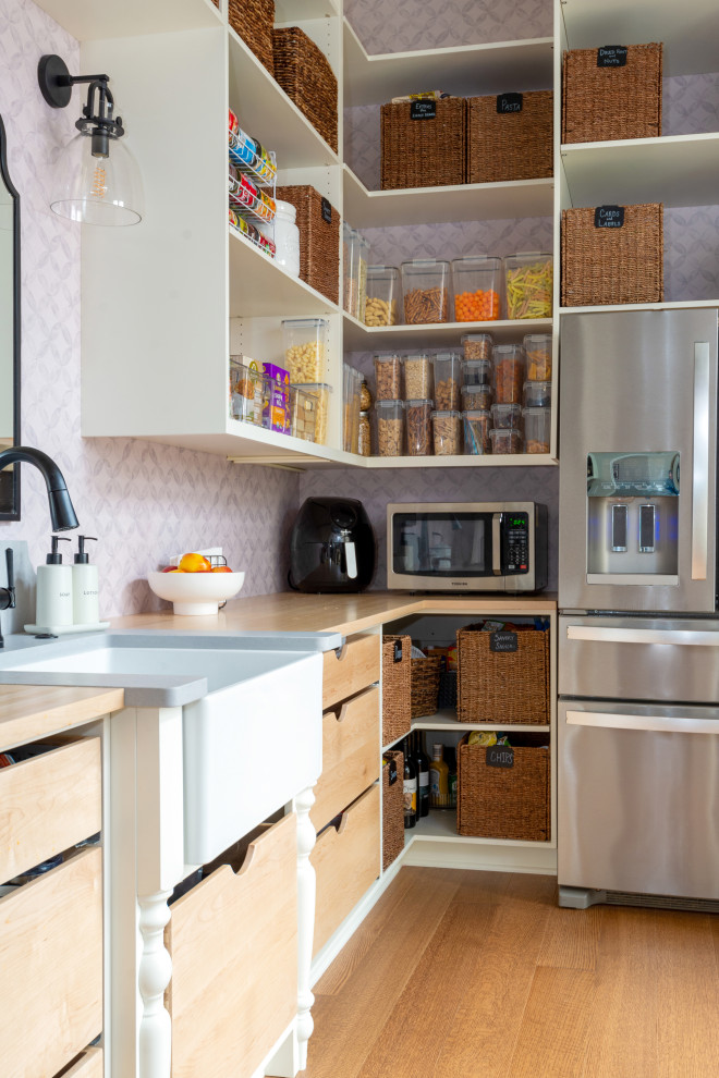 Eat-in kitchen - large medium tone wood floor and exposed beam eat-in kitchen idea with white backsplash, stainless steel appliances and an island