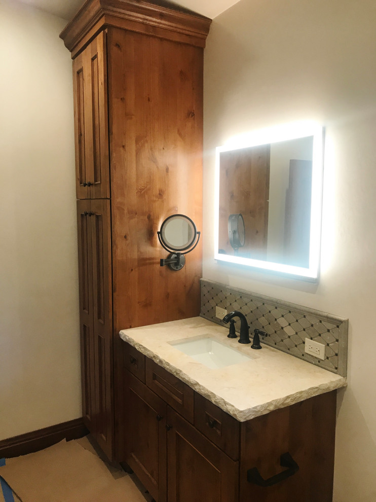 Bathroom - mid-sized rustic master single-sink bathroom idea with recessed-panel cabinets, medium tone wood cabinets, limestone countertops and a built-in vanity