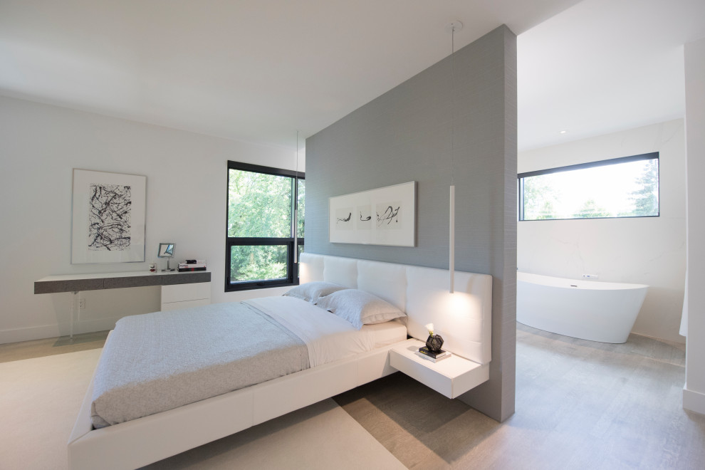 Inspiration for a large contemporary master bedroom in Toronto with white walls, light hardwood floors and beige floor.