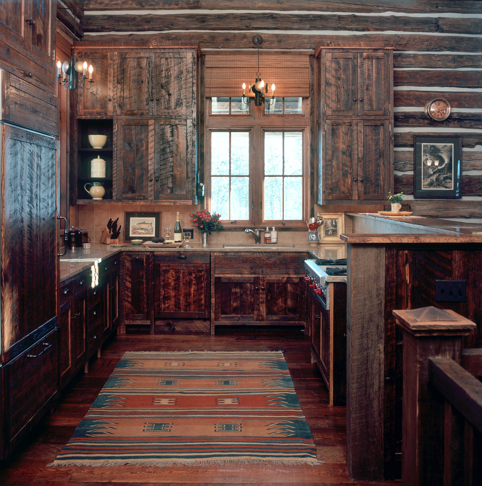 Country u-shaped kitchen in Other with dark wood cabinets.