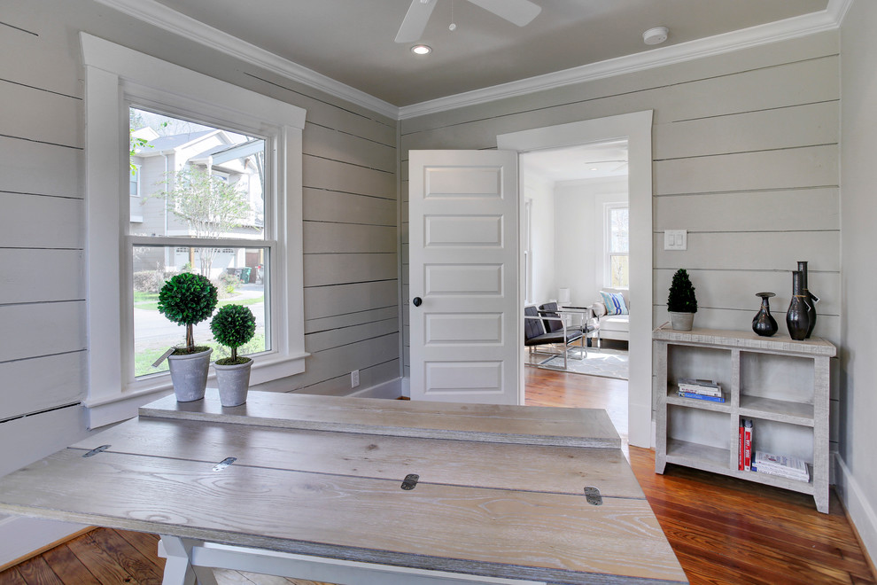 Mid-sized country home office in Houston with grey walls, dark hardwood floors, a freestanding desk and brown floor.