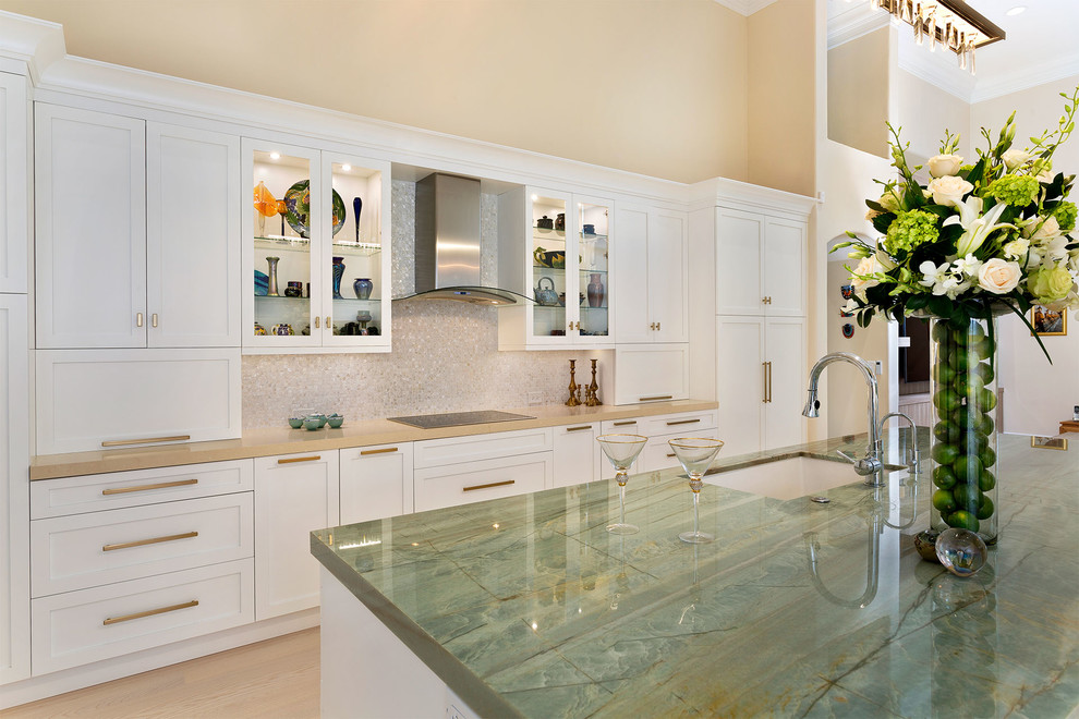 Example of a mid-sized transitional l-shaped light wood floor and beige floor enclosed kitchen design in Miami with an undermount sink, recessed-panel cabinets, white cabinets, marble countertops, beige backsplash, mosaic tile backsplash, stainless steel appliances, an island and multicolored countertops