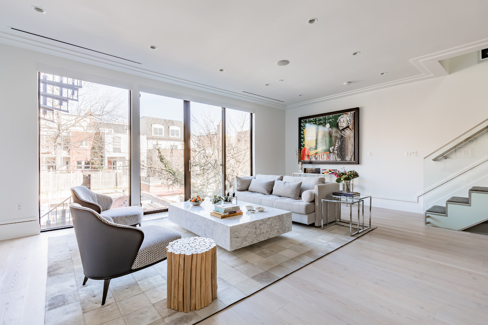 Photo of a mid-sized modern open concept living room in DC Metro with white walls, light hardwood floors, no fireplace, no tv and beige floor.