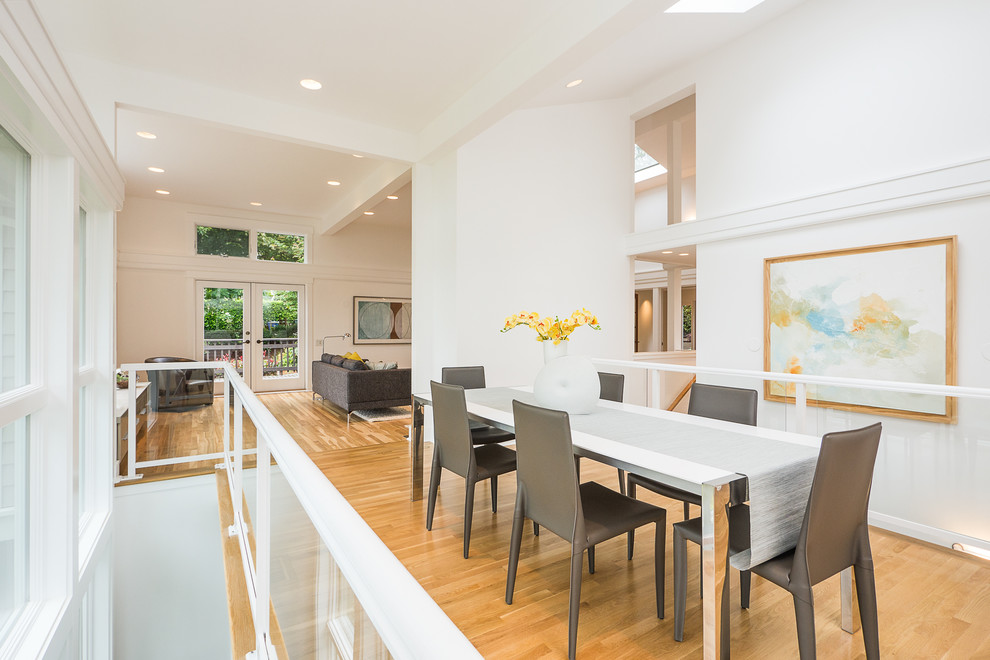 Design ideas for a contemporary dining room in Seattle with white walls and medium hardwood floors.
