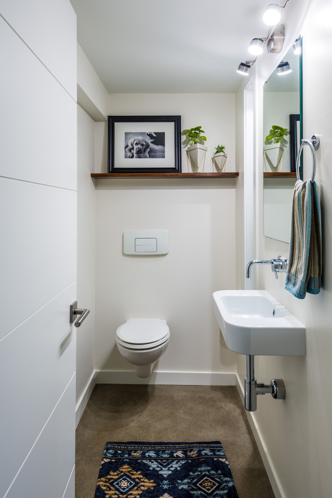 Powder room - small contemporary concrete floor and gray floor powder room idea in Seattle with a wall-mount toilet, a wall-mount sink and beige walls