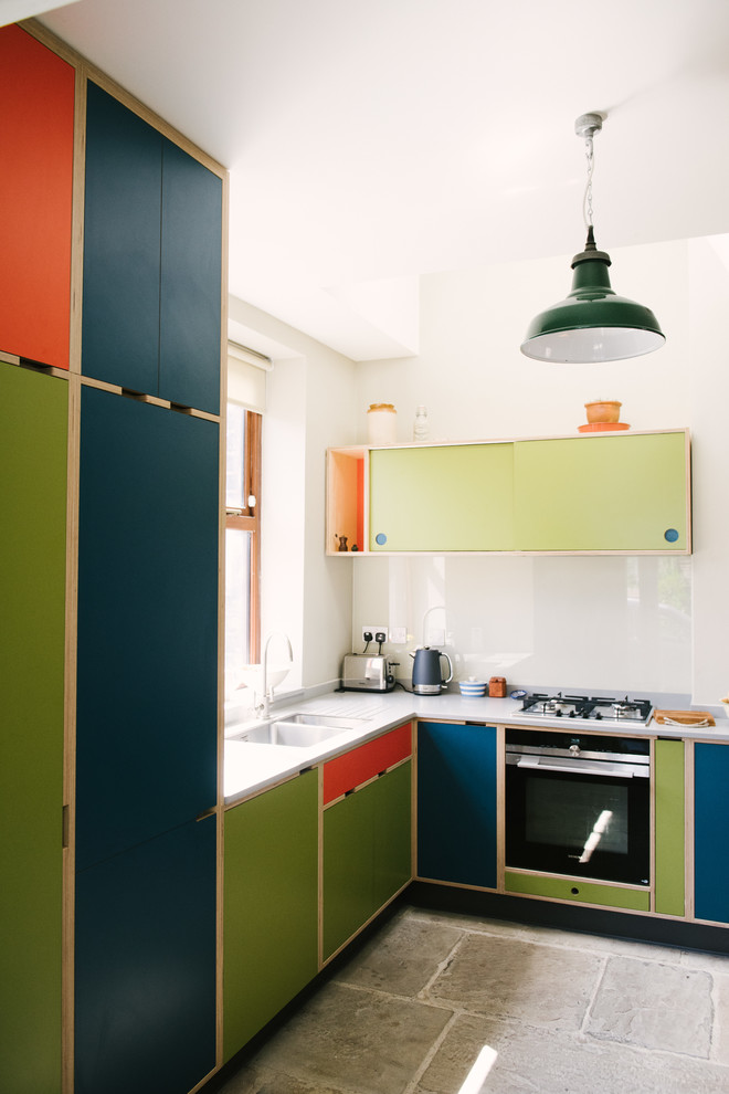 This is an example of a mid-sized contemporary l-shaped kitchen in Other with a double-bowl sink, flat-panel cabinets, green cabinets, white splashback, glass sheet splashback, panelled appliances and grey benchtop.