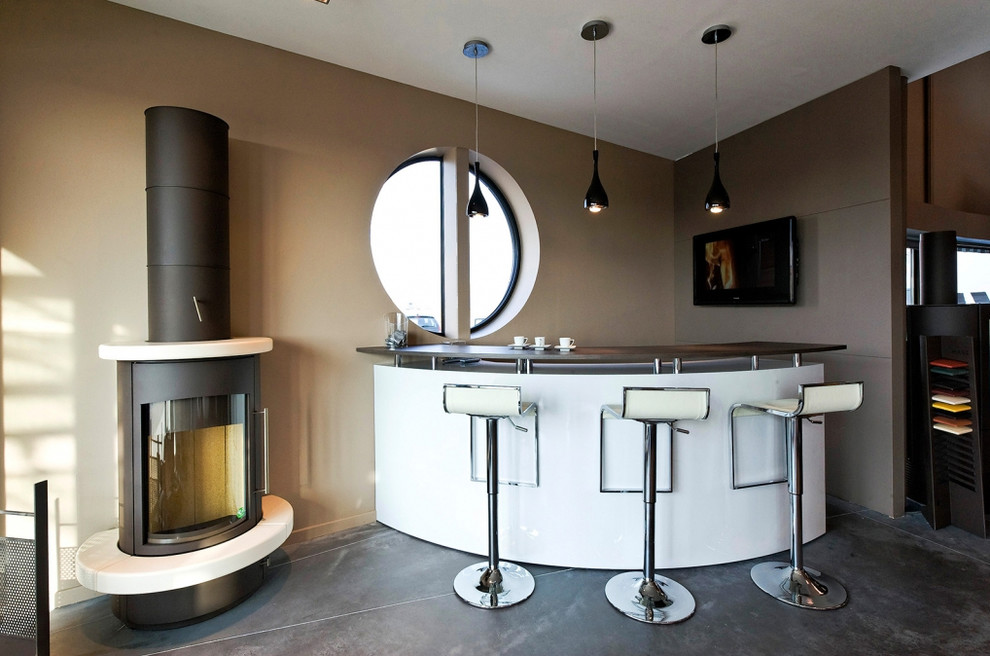 This is an example of a mid-sized contemporary u-shaped seated home bar in Strasbourg with beaded inset cabinets, white cabinets, stainless steel benchtops, white splashback, ceramic floors and grey floor.