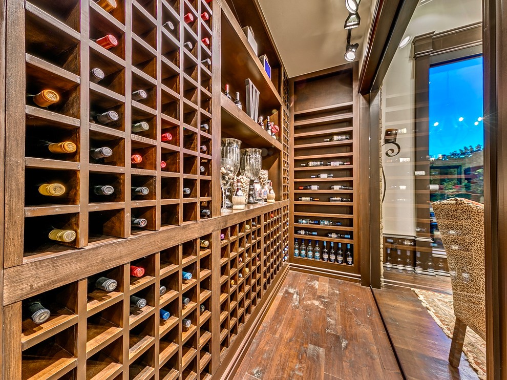 Design ideas for a small mediterranean wine cellar in Oklahoma City with medium hardwood floors and storage racks.