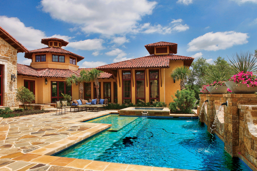Inspiration for a huge backyard stone and rectangular pool remodel in Austin