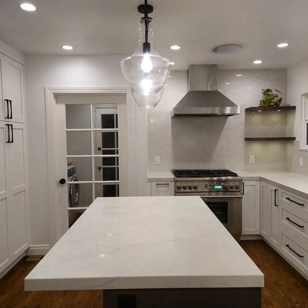 Example of a mid-sized transitional u-shaped eat-in kitchen design in San Francisco with shaker cabinets, white cabinets, quartz countertops, white backsplash, quartz backsplash, stainless steel appliances, an island and white countertops