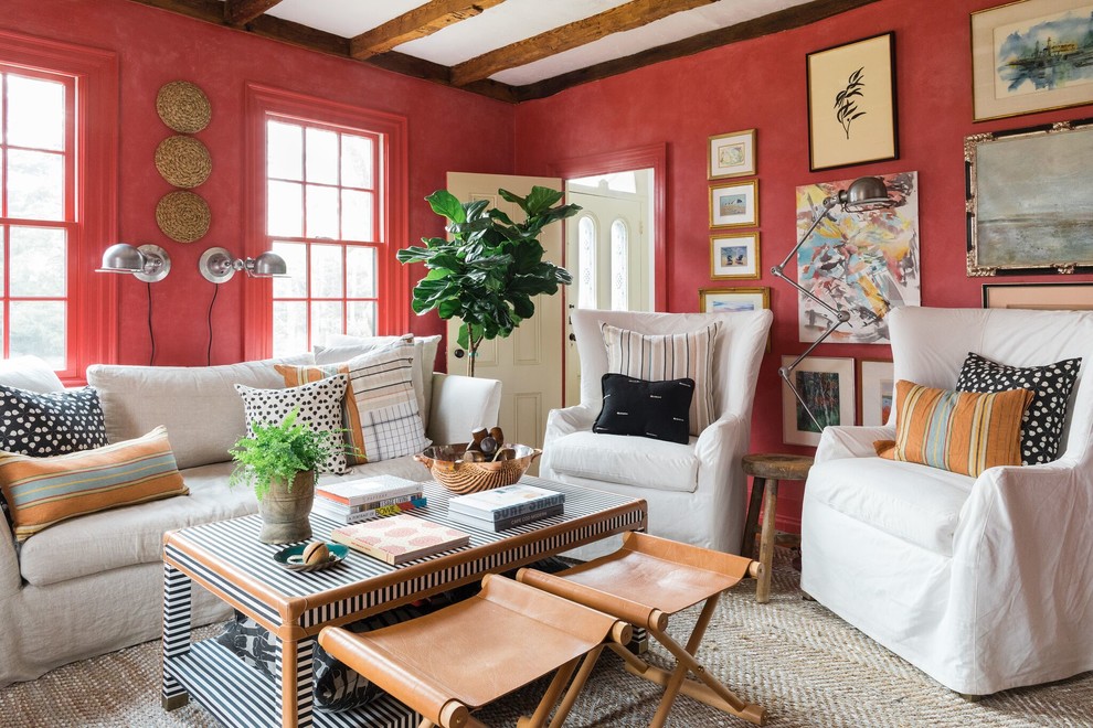 This is an example of a beach style enclosed living room in Boston with red walls.