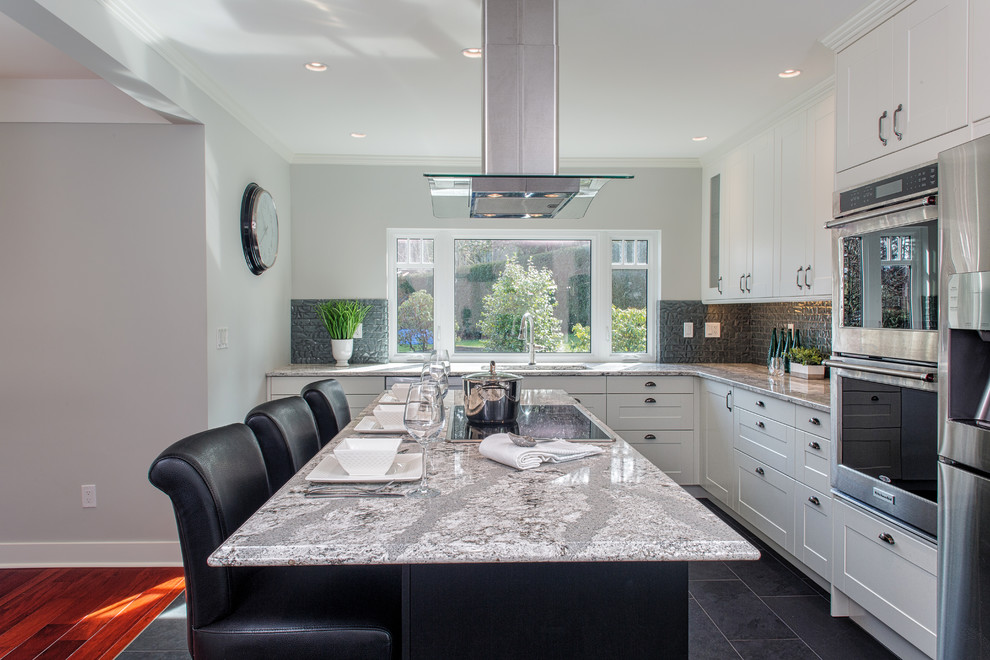 Large contemporary l-shaped kitchen pantry in Vancouver with an undermount sink, recessed-panel cabinets, white cabinets, quartzite benchtops, grey splashback, glass tile splashback, stainless steel appliances, porcelain floors and with island.