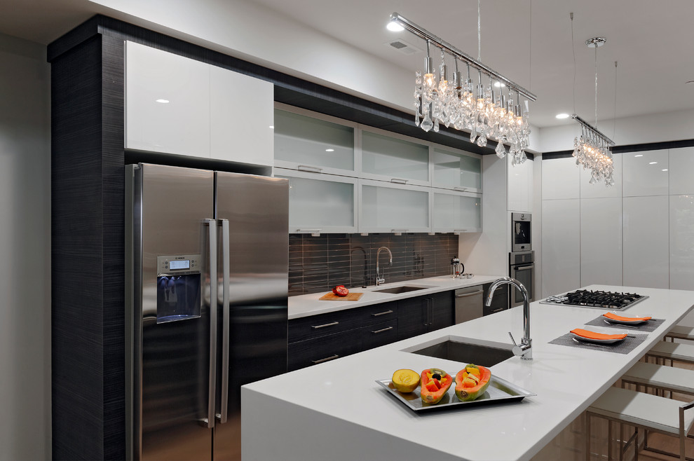 Inspiration for a mid-sized contemporary galley eat-in kitchen in DC Metro with an undermount sink, flat-panel cabinets, dark wood cabinets, quartzite benchtops, grey splashback, glass tile splashback, stainless steel appliances, with island, concrete floors and beige floor.