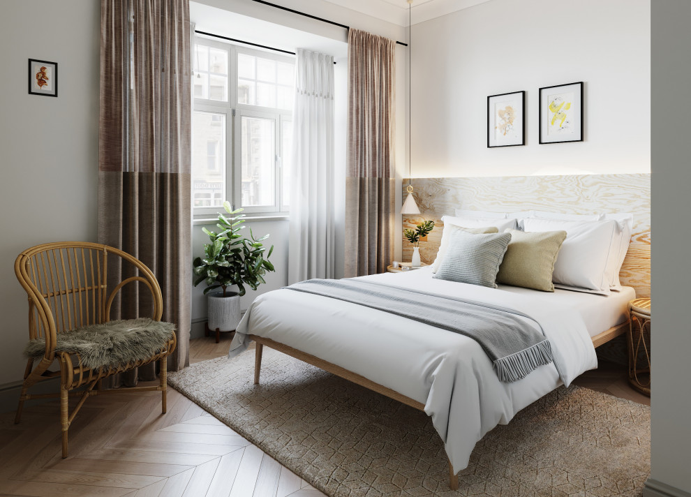На фото: маленькая хозяйская, серо-белая спальня в скандинавском стиле с белыми стенами, полом из ламината и коричневым полом без камина для на участке и в саду