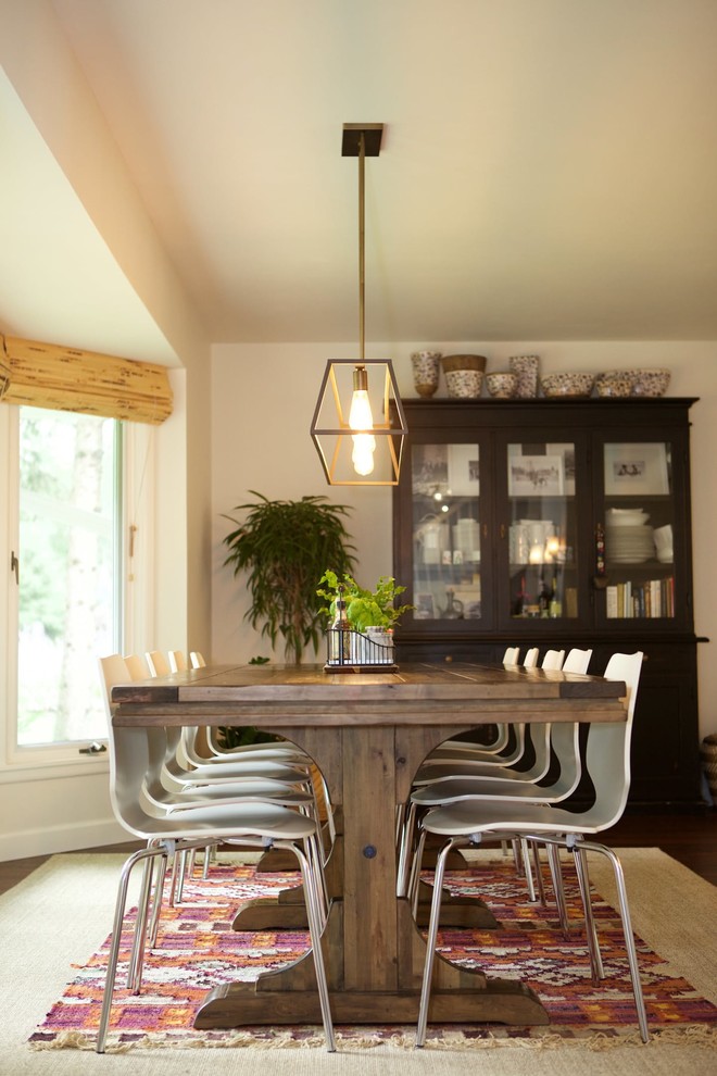 Inspiration for a mid-sized eclectic kitchen/dining combo in Houston with white walls and dark hardwood floors.