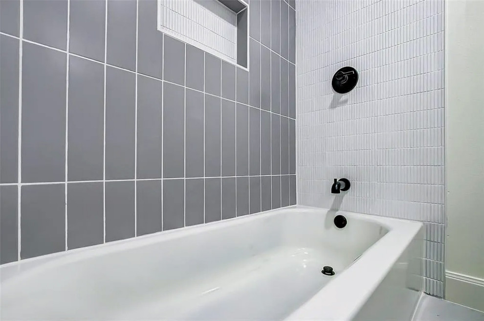 Inspiration for a mid-sized kids' gray tile and marble tile double-sink tub/shower combo remodel with white cabinets, white walls, quartzite countertops, white countertops and a built-in vanity