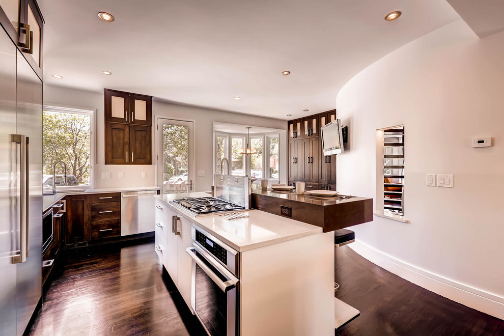 Inspiration for a large transitional l-shaped dark wood floor and brown floor eat-in kitchen remodel in Denver with an undermount sink, shaker cabinets, dark wood cabinets, quartz countertops, stainless steel appliances and two islands