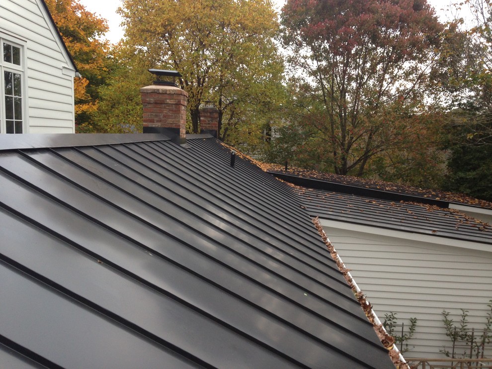 Inspiration for a large transitional white two-story wood gable roof remodel with a metal roof