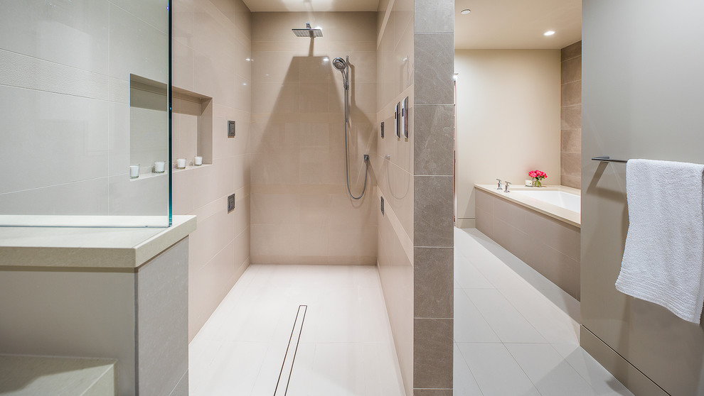 Photo of a mid-sized contemporary master bathroom in Seattle with flat-panel cabinets, medium wood cabinets, an alcove tub, an open shower, a two-piece toilet, beige tile, stone tile, beige walls, porcelain floors, an undermount sink and engineered quartz benchtops.