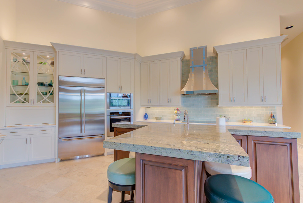 Example of a large transitional single-wall enclosed kitchen design with an undermount sink, flat-panel cabinets, white cabinets, quartz countertops, blue backsplash, stone tile backsplash, stainless steel appliances and an island