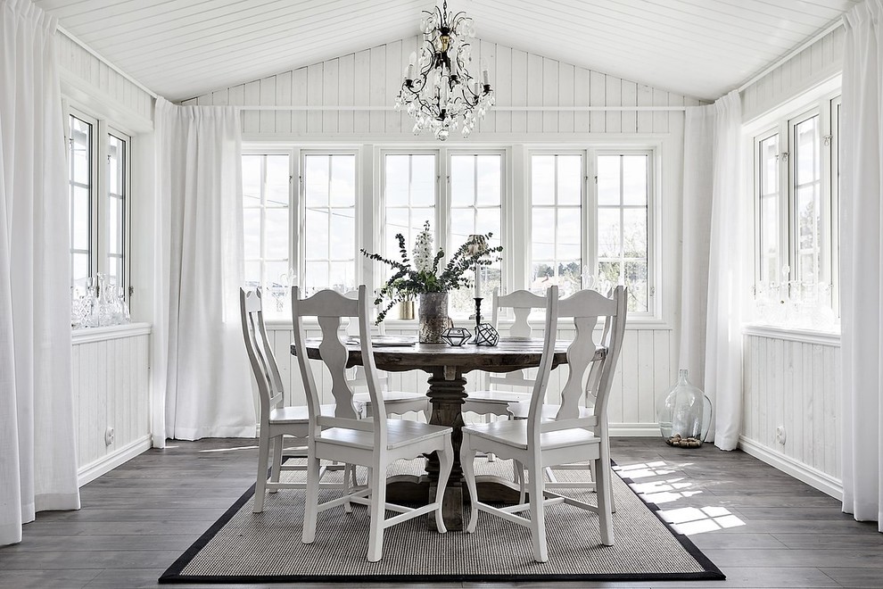 Inspiration for a country separate dining room in Gothenburg with white walls, dark hardwood floors and grey floor.