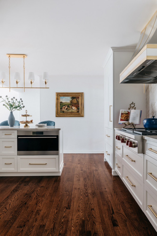 Inspiration for a large transitional dark wood floor and brown floor eat-in kitchen remodel in Chicago with recessed-panel cabinets, white cabinets, quartzite countertops, beige backsplash, a peninsula and beige countertops