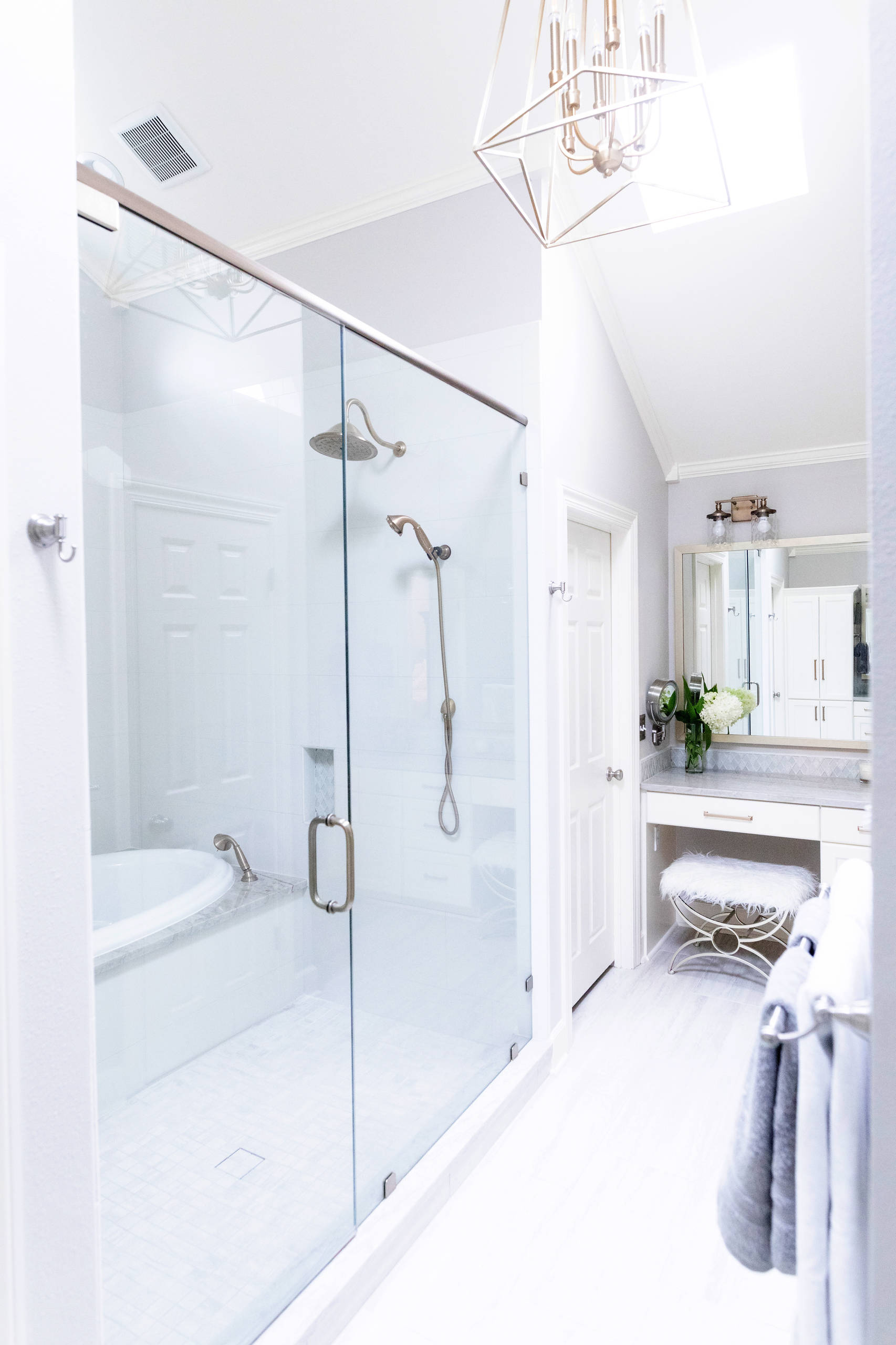 Inspiration for a small master white tile gray floor drop-in bathtub remodel in New Orleans with white cabinets, gray walls, a hinged shower door and gray countertops