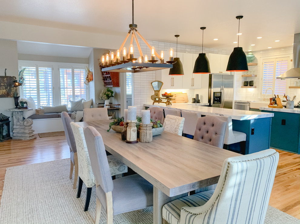 Mid-sized transitional u-shaped medium tone wood floor open concept kitchen photo in Denver with a farmhouse sink, flat-panel cabinets, turquoise cabinets, quartzite countertops, white backsplash, ceramic backsplash, stainless steel appliances and white countertops