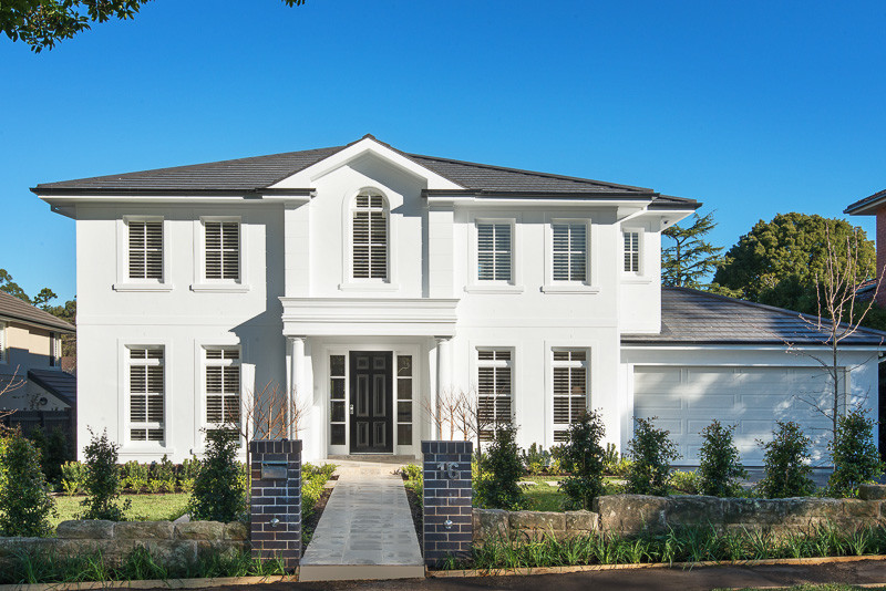 Inspiration for a large contemporary two-storey stucco white exterior in Sydney with a hip roof.