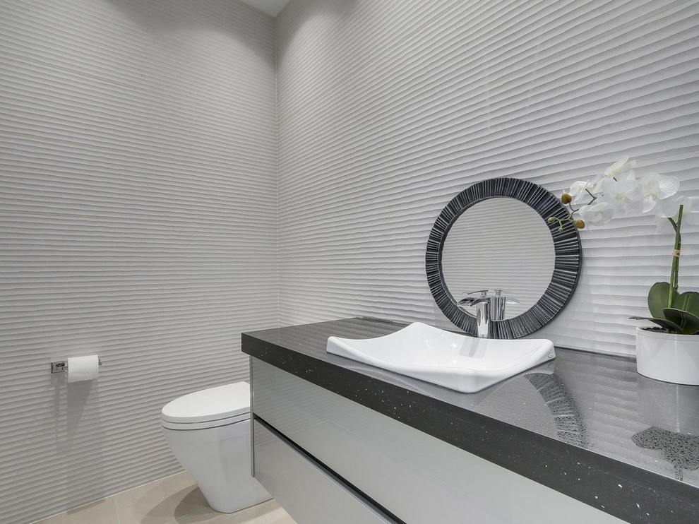 This is an example of a mid-sized contemporary powder room in Vancouver with flat-panel cabinets, white cabinets, a two-piece toilet, white walls, porcelain floors, a vessel sink, engineered quartz benchtops and beige floor.