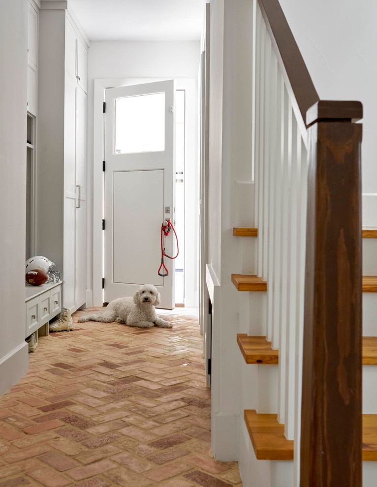 Design ideas for a country mudroom in Dallas with white walls, brick floors, a single front door and a white front door.
