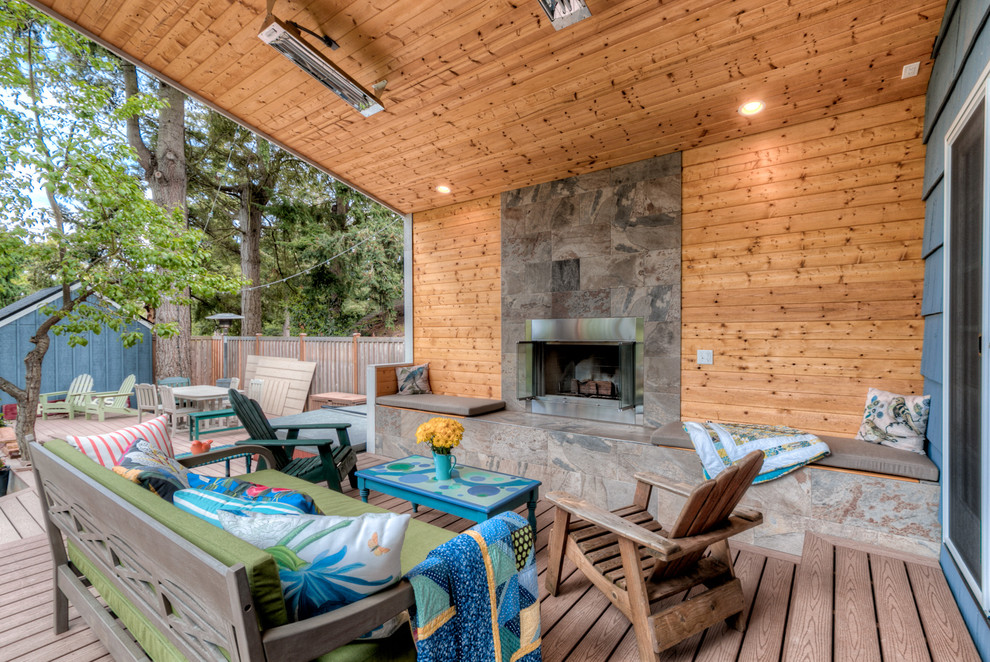 Design ideas for a large arts and crafts backyard deck in Seattle with a fire feature and a roof extension.
