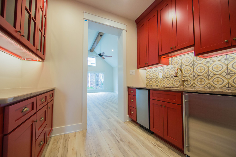Inspiration for a large timeless galley medium tone wood floor and brown floor kitchen pantry remodel in Indianapolis with an undermount sink, recessed-panel cabinets, red cabinets, granite countertops, multicolored backsplash, porcelain backsplash, stainless steel appliances and multicolored countertops