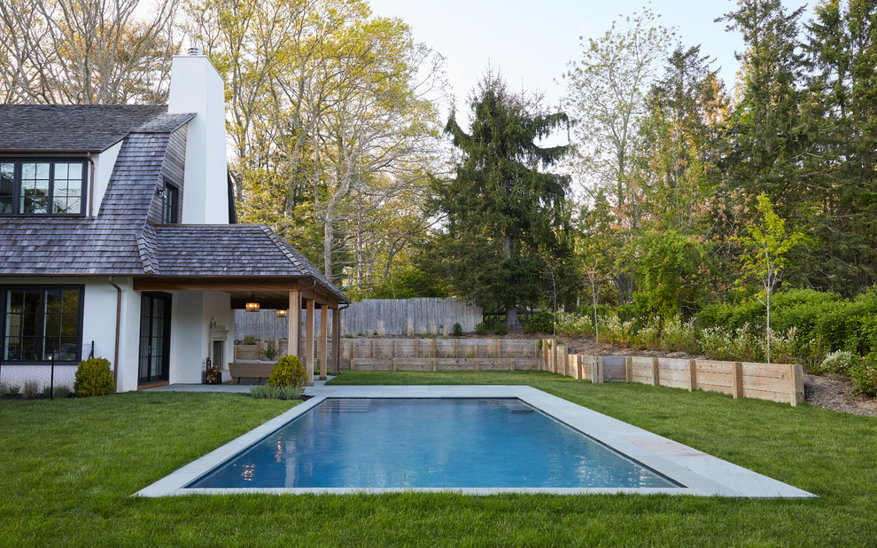 Country backyard rectangular lap pool in New York.