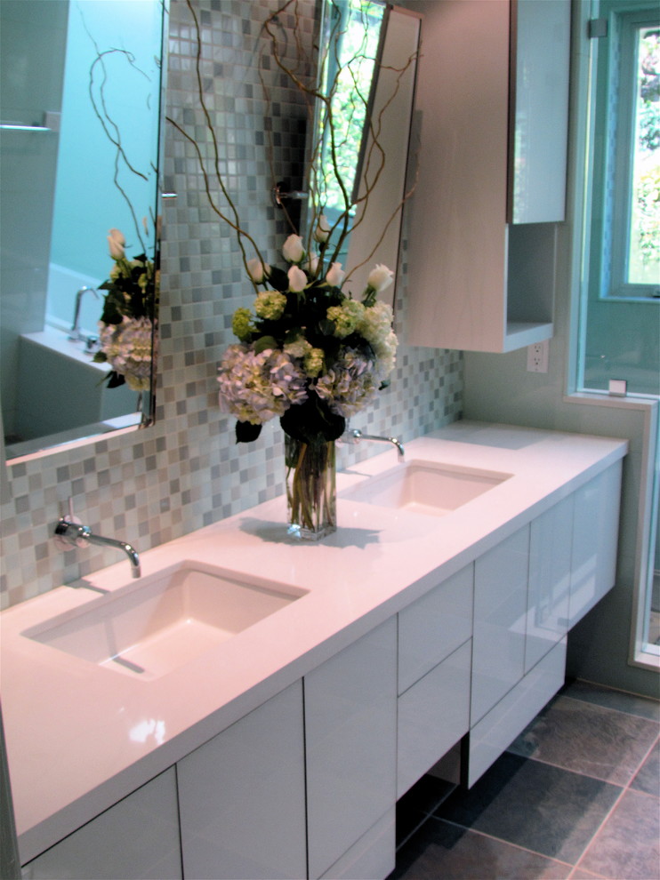 Inspiration for a mid-sized contemporary master bathroom in San Francisco with an undermount sink, glass-front cabinets, white cabinets, engineered quartz benchtops, an undermount tub, an alcove shower, blue tile, porcelain tile, blue walls and slate floors.