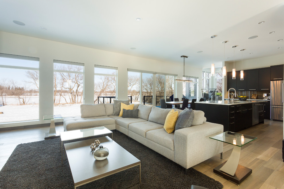 This is an example of a mid-sized contemporary formal open concept living room in Other with white walls, light hardwood floors, no tv, a ribbon fireplace, a stone fireplace surround and brown floor.