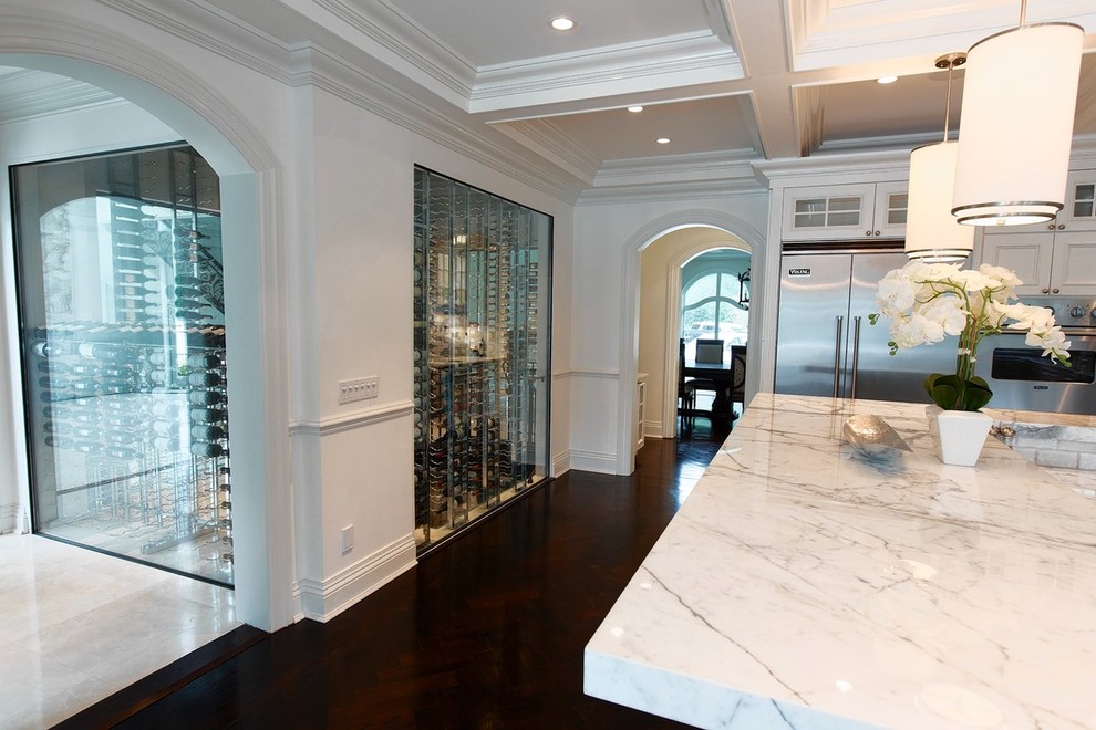 Photo of a large contemporary wine cellar in New York with marble floors and display racks.