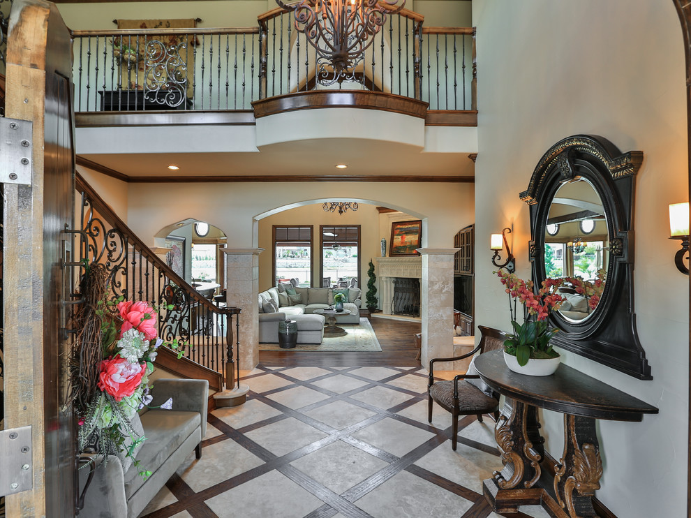 Large mediterranean foyer in Dallas with white walls, limestone floors and beige floor.